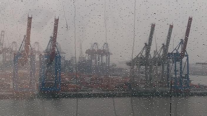 Cranes on rainy day in industrial harbor, Hamburg, Germany