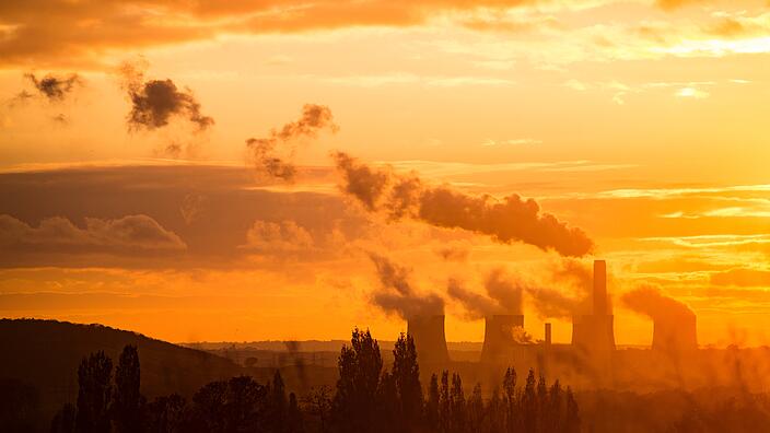 Ratcliffe-on-Soar Power Staton with smoking chimneys at sunset